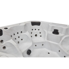Luxury Spas Eclipse hot tub for 6, featuring a sleek design with a smooth surface and built-in LED lights.