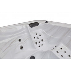 Luxury Spas 5-person hot tub with a sleek design, LED lights, and comfortable seating for relaxation and wellness.