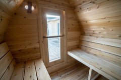 Dundalk 4-person cedar barrel sauna made from Canadian timber, 7x7 size, featuring rounded design and natural wood finish.