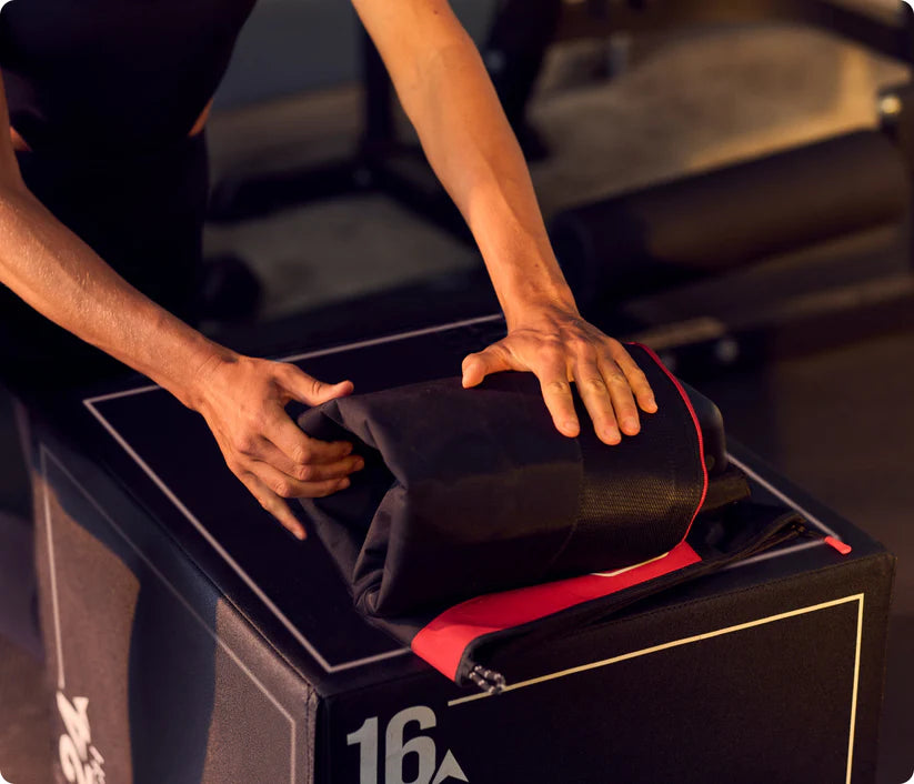 Person opening a black suitcase with red interior