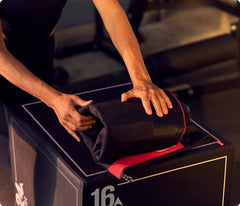 Person opening a black suitcase with red interior