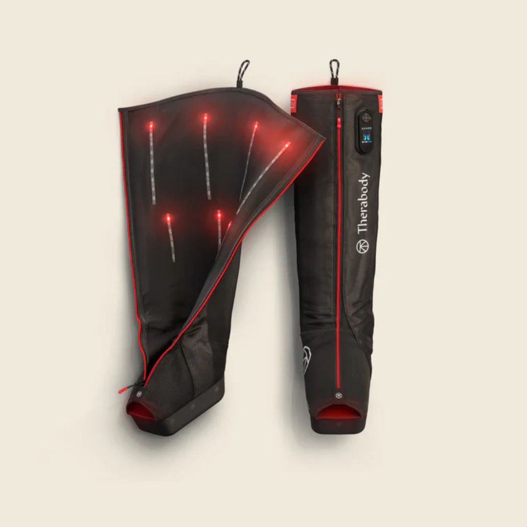 Black and red heated leg sleeves with visible branding on a beige background