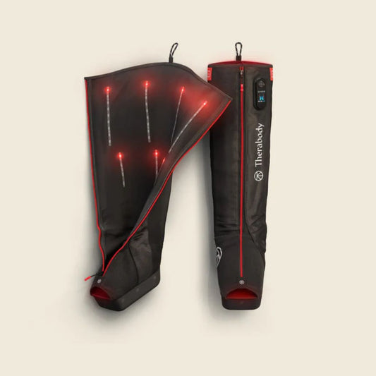Black and red heated leg sleeves with visible branding on a beige background