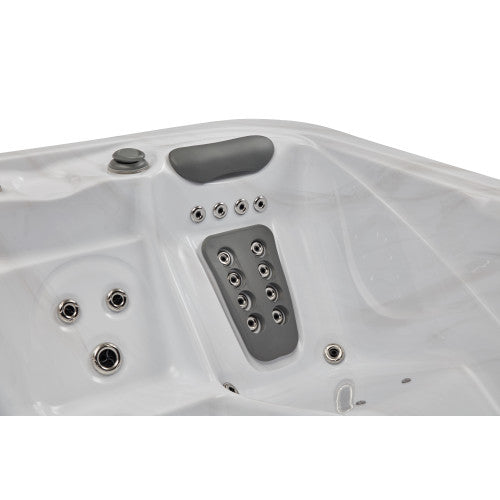 Luxury Spas Danika 5-person hot tub with sleek design, built-in jets, and modern controls in a serene outdoor setting.