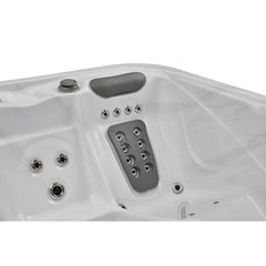 Luxury Spas Danika 5-person hot tub with sleek design, built-in jets, and modern controls in a serene outdoor setting.