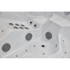 Luxury Spas Danika 5-person hot tub with a sleek rectangular design and built-in jets, featuring a modern gray exterior.