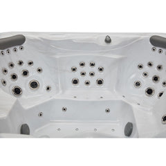 Luxury Spas Danika 5-person hot tub with blue water, built-in LED lights, and comfortable seating
