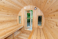 6-person Eastern White Cedar barrel sauna with porch, crafted by Dundalk, featuring natural wood finish.