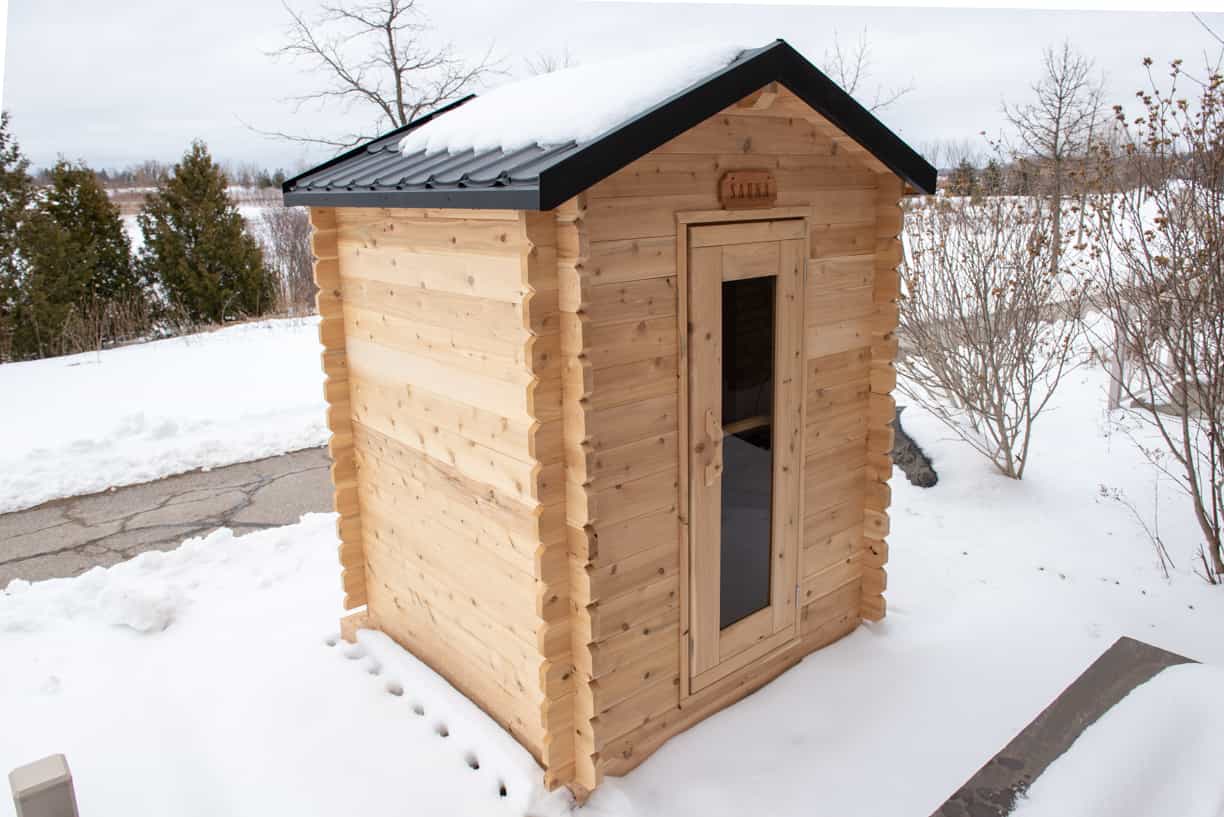 Dundalk 6x6 cedar cabin sauna with 2-tier benches for 3 persons, electric heating, natural wood finish.