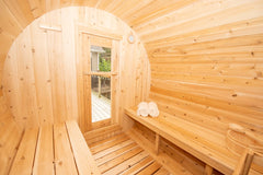 Dundalk cedar barrel sauna for 4 people in natural wood finish, perfect for backyard relaxation.