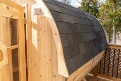 Dundalk 4-person cedar barrel sauna with natural wood finish, designed for outdoor use in backyards.