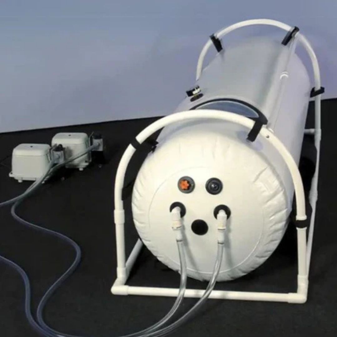 White inflatable hyperbaric chamber with dual air valves and external air pump, Summit To Sea model.
