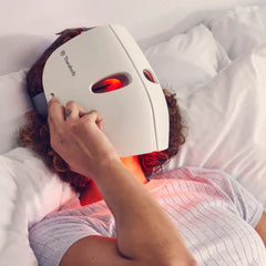 woman lying in bed with theraface mask